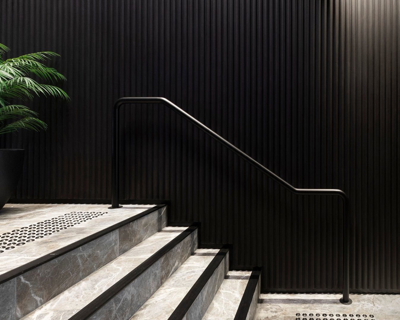 staircase with black paneling.