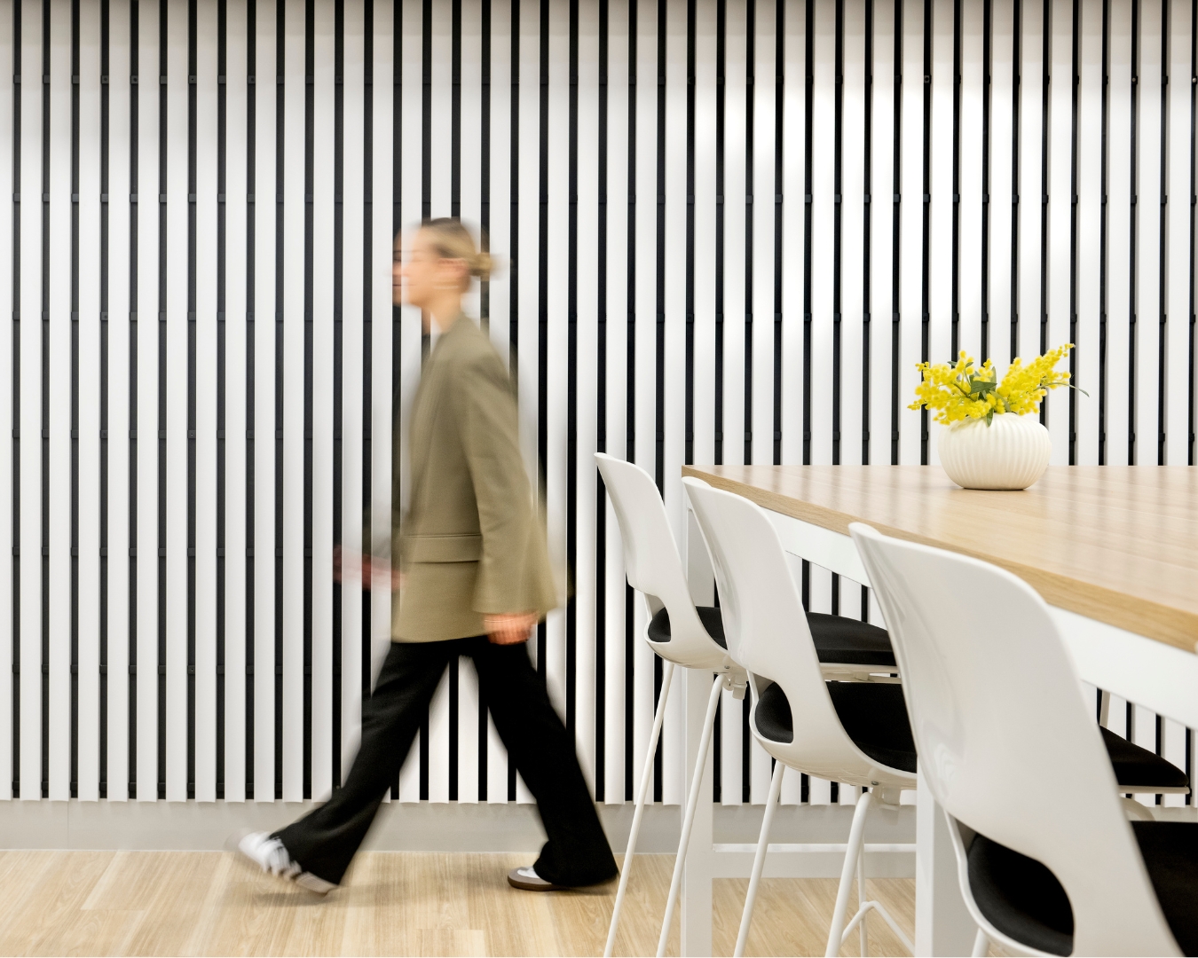 girl walking with table and white paneling